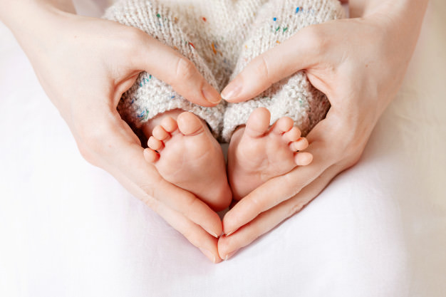 baby-feet-mother-hands-tiny-newborn-baby-s-feet-female-heart-shaped-hands-closeup_139345-543